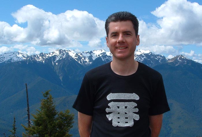 John Hunter with snow covered mountains in the background