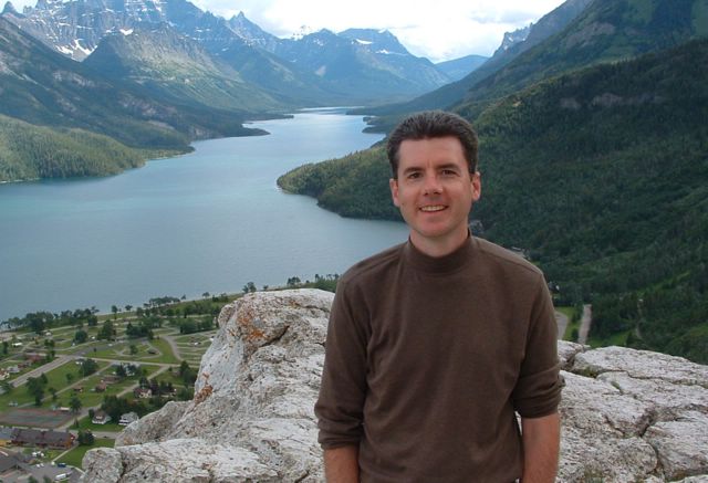 photo of John Hunter with a river and mountains in the background