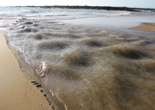 Creek joining the Andaman Sea photo of rushing water joining the sea