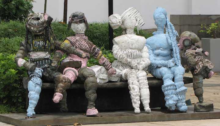 Street art in Singapore 4 people sitting and a kid