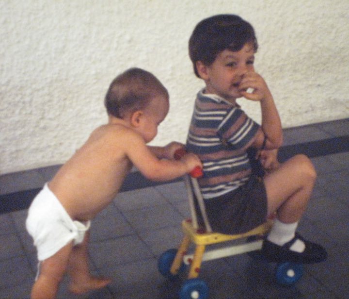 My little brother, Justin, pushing me on a scooter at our house in Singapore.